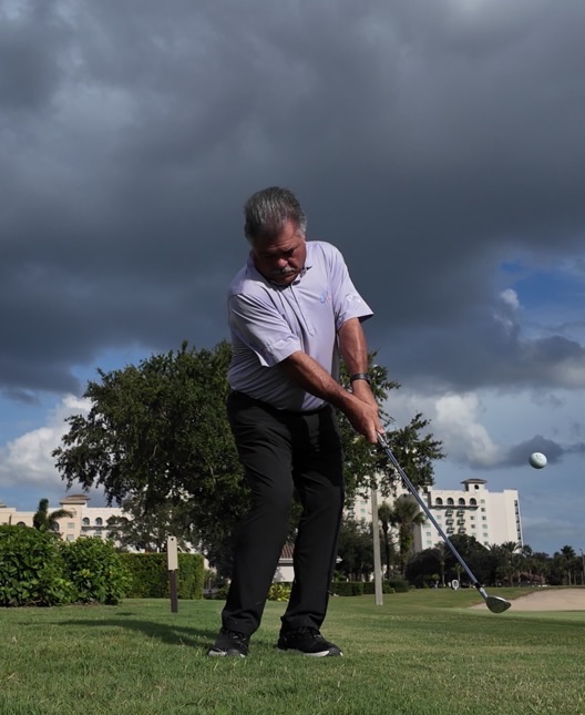 John Hughes hitting a chip shot on the course at ChampionsGate